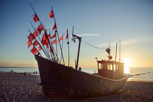 fisherman boats at sunrise time on the beach in summer