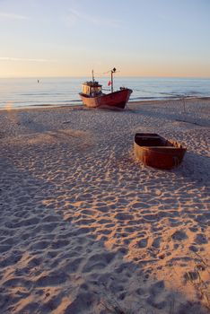 fisherman boats at sunrise time on the beach in summer