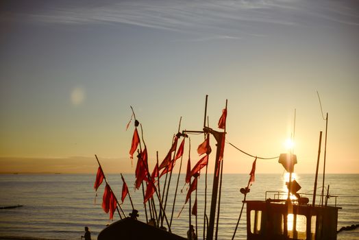 fisherman boats at sunrise time on the beach in summer