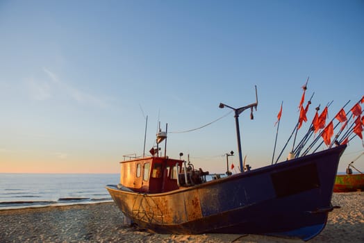 fisherman boats at sunrise time on the beach in summer