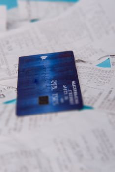 Close-up Of Credit Card On Shopping Receipt On Blue Background