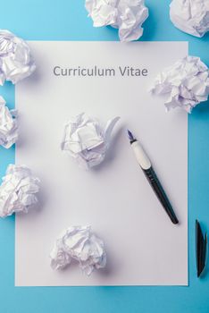 Curriculum vitae written on an blank white paper on blue background