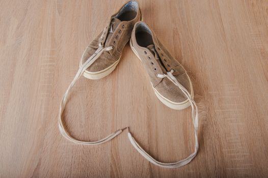 Blue lovely used sneakers on wooden desk