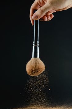 close up of a make up powder and a brush. makeup brush with powder foundation