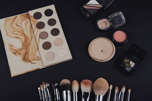 close up of a make up powder and a brush. makeup brush with powder foundation