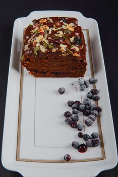 Chocolate cake with raisins lies on the table