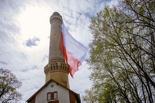 Polish flag hung on at historical lighthouse located in Swinoujscie, Poland, The construction was build in 1828 and height is 65 meters. 19th century. Top tallest Lighthouse in the World