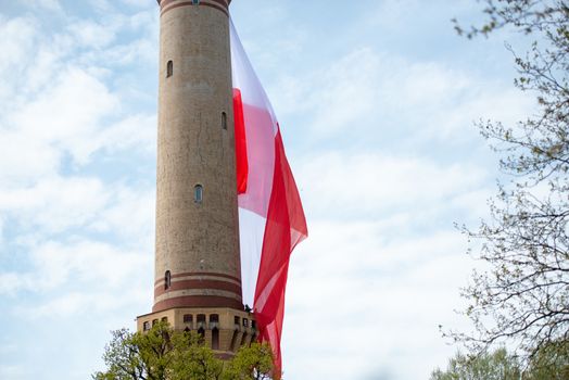 Polish flag hung on at historical lighthouse located in Swinoujscie, Poland, The construction was build in 1828 and height is 65 meters. 19th century. Top tallest Lighthouse in the World