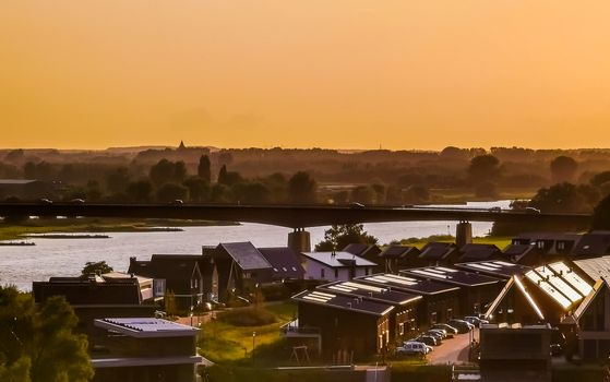 view on modern houses and the city bridge in rhenen during sunset, Rustic town in the Netherlands