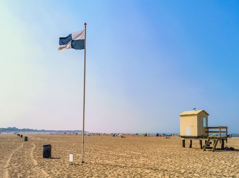 the beach of vrouwenpolder with flag and beach cottage, Zeeland, The Netherlands