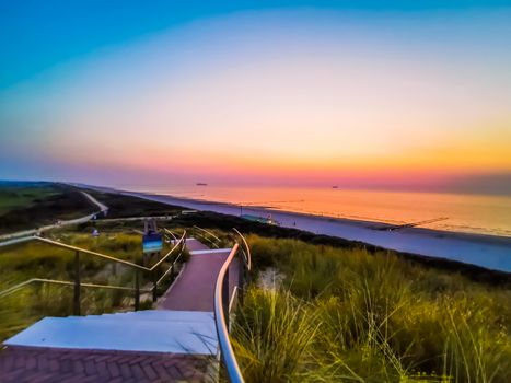 colorful sunset in the dunes of domburg with view on the beach, Zeeland, The netherlands