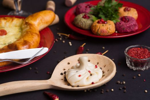 Georgian food on black table. khinkali, phali,  khachapuri with tomatos and adjika