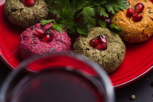 Georgian food on black table.Phali and glass of red wine.