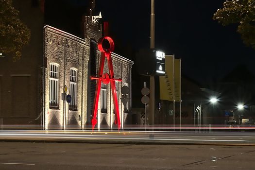 This giant pair of compasses is in front of the Cuypershuis in Roermond, a museum in honor of the work of the great architect Cuypers who lived in Roermond at the place where the museum is now. Shot in the summer at night with a long exposure.