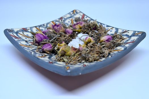 Moroccan pottery dish filled with dried flowers.