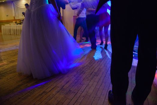 Bride and groom dancing the first dance at their wedding day. Guest on the dancefloor