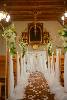 Church sanctuary before a wedding ceremony. Empty chairs for bride and groom