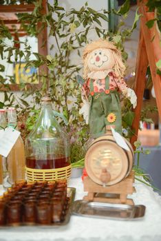 Bottle of cold vodka and wine bottle in bucket with ice and orange juice in jug on table, copy space. Alcohol bottles in ice bucket in restaurant. Wedding party