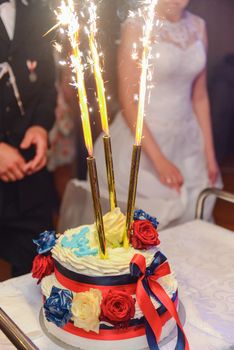 Delicious Wedding Cake at the party. Smoke and fire effects