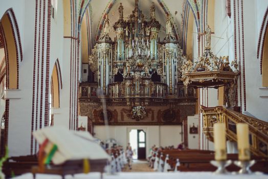 Church sanctuary before a wedding ceremony. Empty chairs for bride and groom