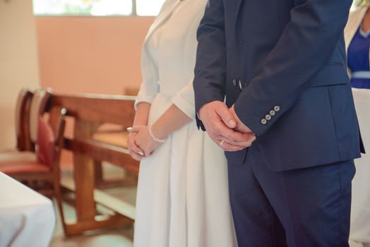 Bride and groom at church wedding during ceremony. Beautiful decoration