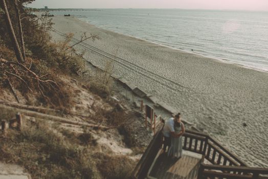 Bride and groom at a photo session in the nature. Baltic sea beach.