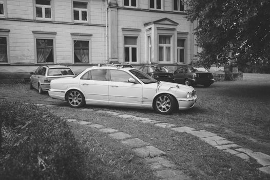 Luxury wedding car decorated with beautiful flowers. Brides and grooms wedding day