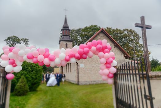 Church exterior during wedding ceremony. Blue sky with sunny weather