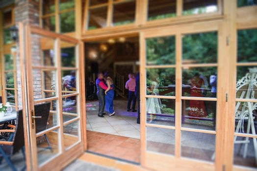 View of restaurants from outside at night. Wedding party.