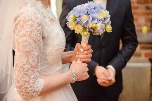 Bride and groom at church wedding during ceremony. Beautiful decoration