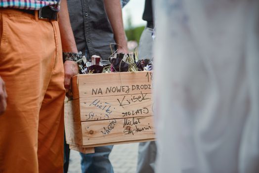 Bottle of cold vodka and wine bottle in bucket with ice and orange juice in jug on table, copy space. Alcohol bottles in ice bucket in restaurant. Wedding party