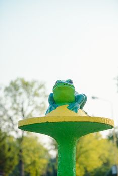 Garden statue green frog waterspout. Golczewo city in Poland