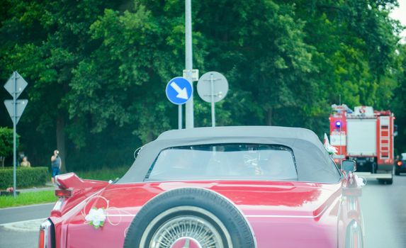 Luxury wedding car decorated with beautiful flowers. Brides and grooms wedding day