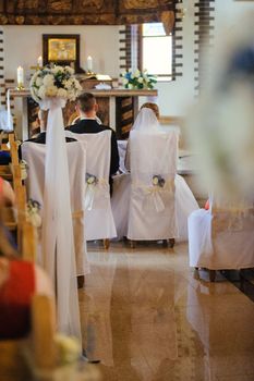 Bride and groom at church wedding during ceremony. Beautiful decoration