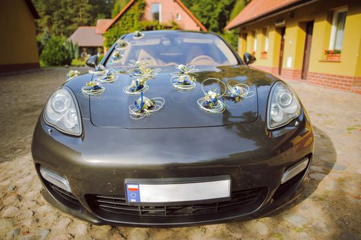 Luxury wedding car decorated with beautiful flowers. Brides and grooms wedding day