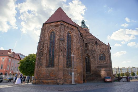 Church exterior during wedding ceremony. Blue sky with sunny weather