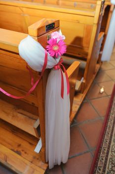 Church sanctuary before a wedding ceremony. Empty chairs for bride and groom