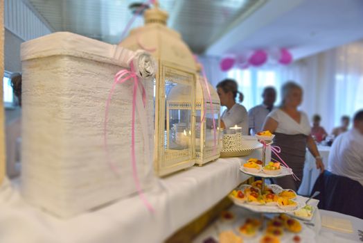 Delicious sweets on candy buffet. Wedding bakes on trays.