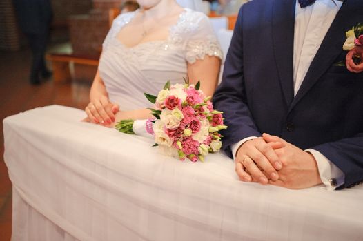 Bride and groom at church wedding during ceremony. Beautiful decoration