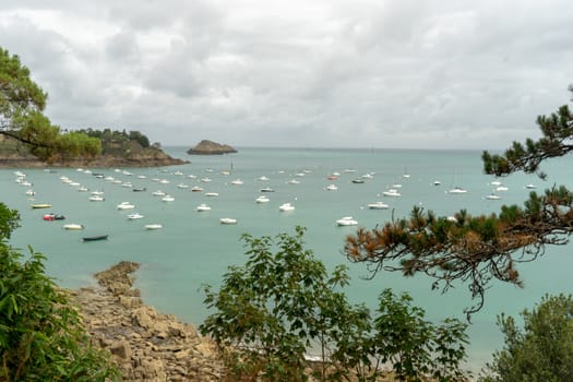 Sea and yachts during tide on sea shore of France in summer