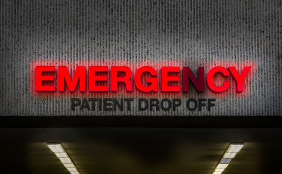 A Rundown Hospital Emergency Room Sign With Broken Light