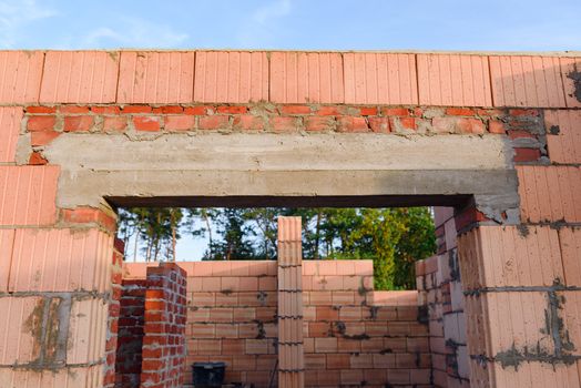 Interior of a Unfinished Red Brick House Walls under Construction without Roofing.