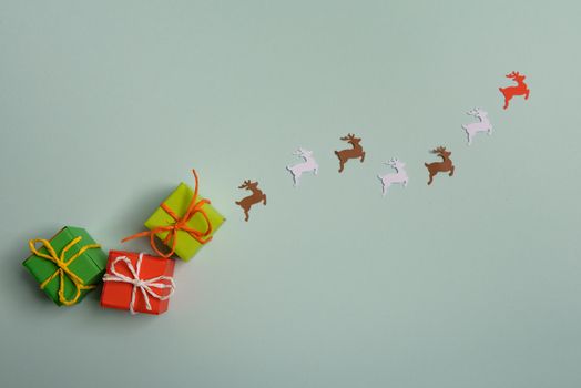 christmas presents nicely decorated with bows and feathers. view from above. Reindeers.