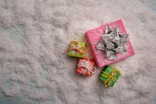 christmas presents nicely decorated with bows and feathers. view from above