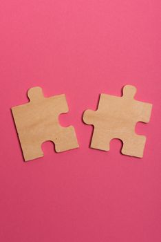 Man hand assembling puzzles on lime background.