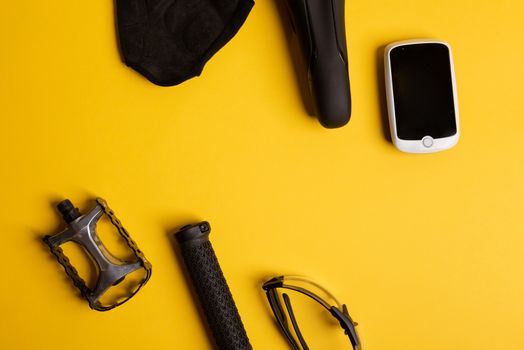 Bicycle, Cycling accessories on the yellow background. view from above
