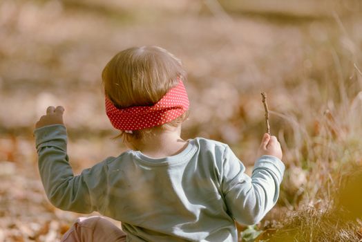 Adorable girl having fun on beautiful autumn day. authentic childhood image