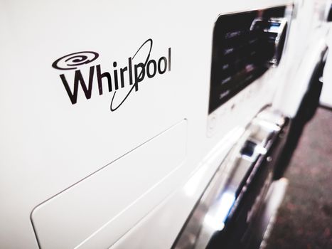 Close up to a Whirlpool brand logo on a white washing machine in Bologna, Italy, circa Nov 2019