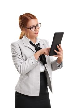 Mobile office concept. Portrait of a young beautiful businesswoman in a suit with glasses with a tablet in hand, isolated on white background. Businesswoman working on a digital tablet.