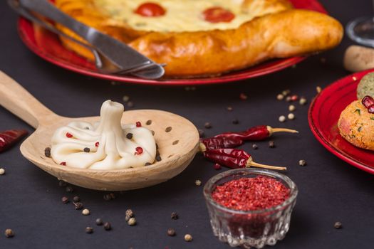 Georgian food on black table. khinkali, phali,  khachapuri with tomatos and adjika